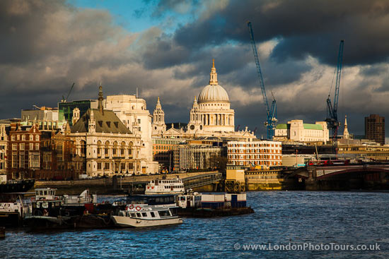 view of st pauls cathedral across the river thames london.