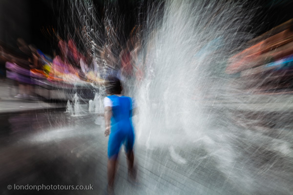 Long exposure of water with person running through the London street 